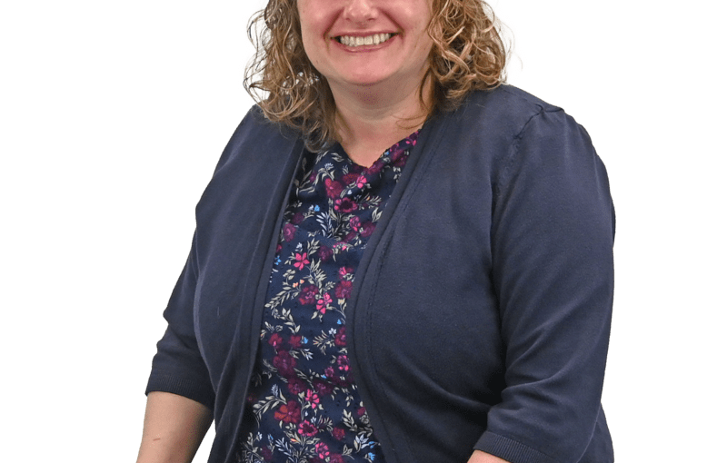 Christine Zasada, Service and Support Administrator smiling at camera wearing navy cardigan and floral top in Sandusky County, Ohio