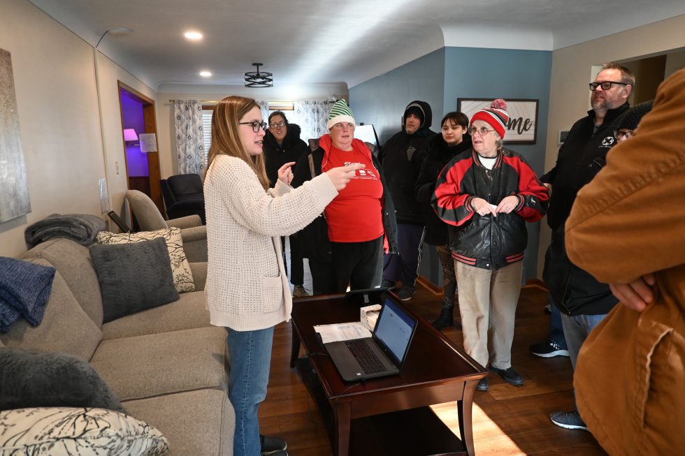 Woman presenting to group of visitors in living room during developmental disability services tour in Sandusky County, Ohio
