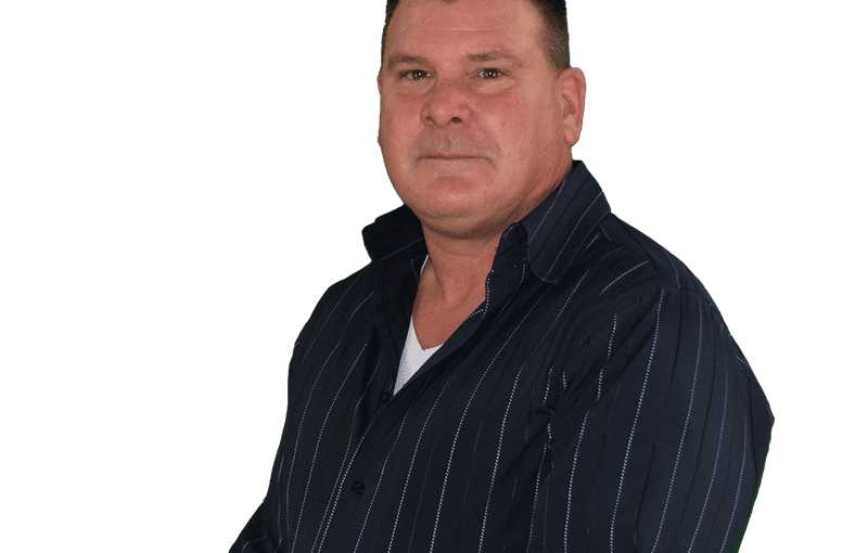 James Dickman, Community Education Coordinator, wearing a dark pinstriped jacket over a white shirt against a white background