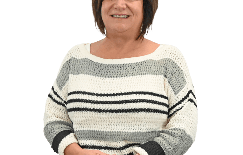 Lisa Celek, Early Intervention Developmental Specialist, smiling while seated wearing a striped sweater, providing developmental disability and autism services in Sandusky County Ohio