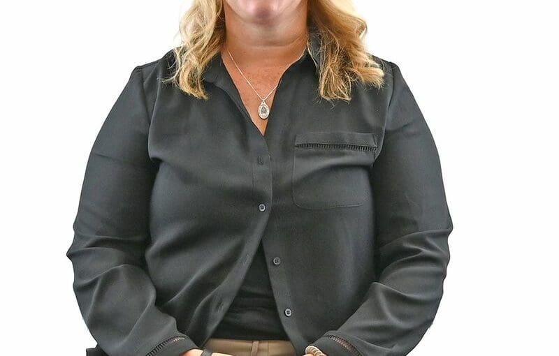 Tracy Foos, developmental disability services staff member in Sandusky County, Ohio, smiling at camera in professional portrait wearing black button-up shirt